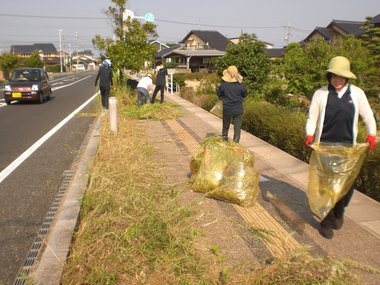 スタッフが歩道の清掃活動を行っている写真